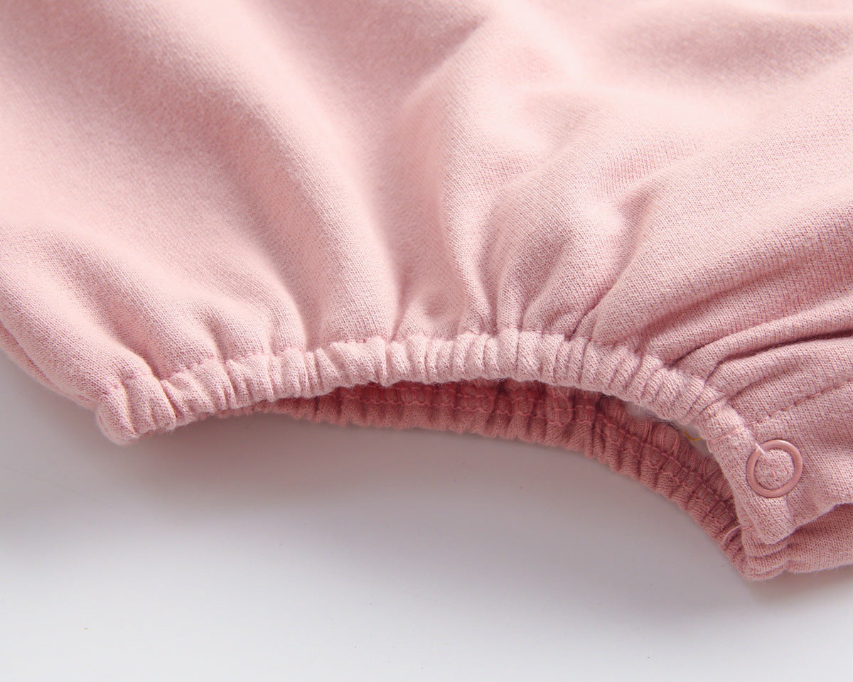 Baby wearing a long-sleeved cartoon print cotton onesie with a matching hat, showcasing a playful design in pink, grey, and brown colors.