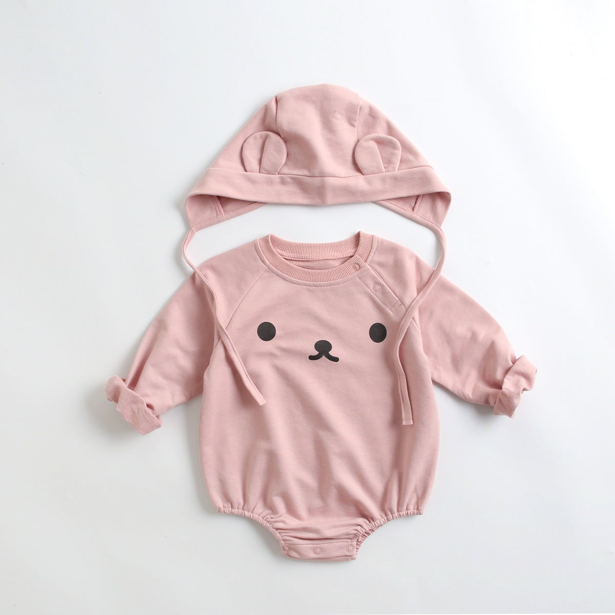 Baby wearing a long-sleeved cartoon print cotton onesie with a matching hat, showcasing a playful design in pink, grey, and brown colors.