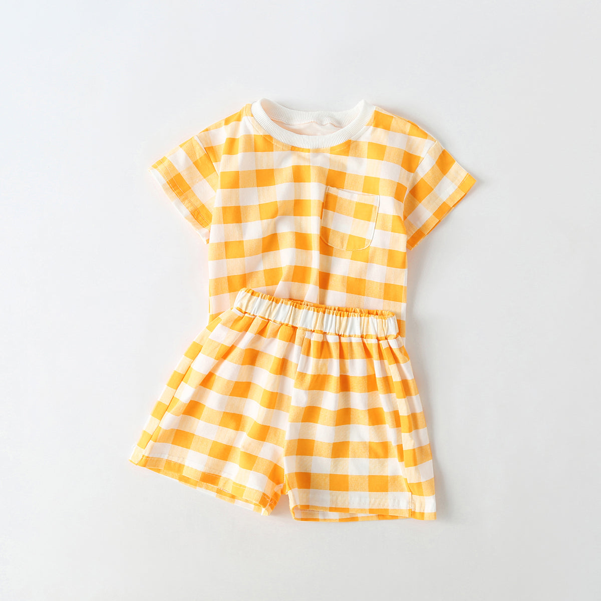 Baby outfit featuring plaid and heart patterns in a tee and shorts set, available in white and yellow colors.