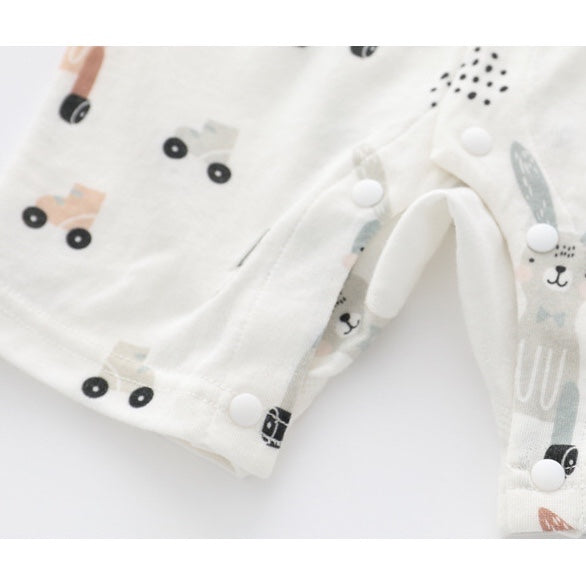 Baby wearing a soft bamboo rabbit graphic jumpsuit in white, showcasing a playful design perfect for summer.
