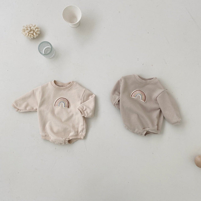 A soft cotton baby bodysuit featuring a rainbow embroidery pattern, available in apricot and coffee colors, designed for comfort and style.