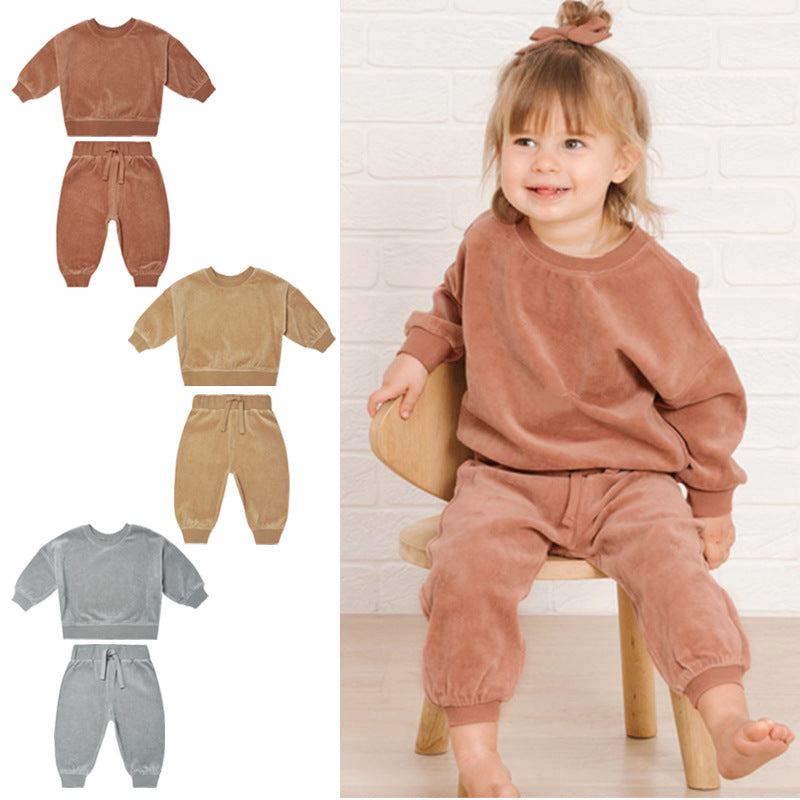 Baby wearing a soft cotton hoodie and trousers in grey, orange, and brown colors, perfect for autumn.
