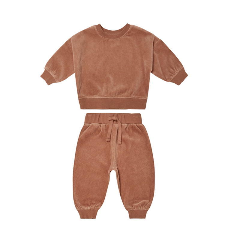 Baby wearing a soft cotton hoodie and trousers in grey, orange, and brown colors, perfect for autumn.