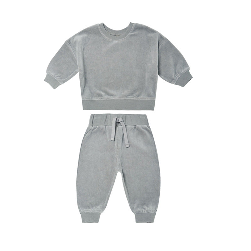 Baby wearing a soft cotton hoodie and trousers in grey, orange, and brown colors, perfect for autumn.