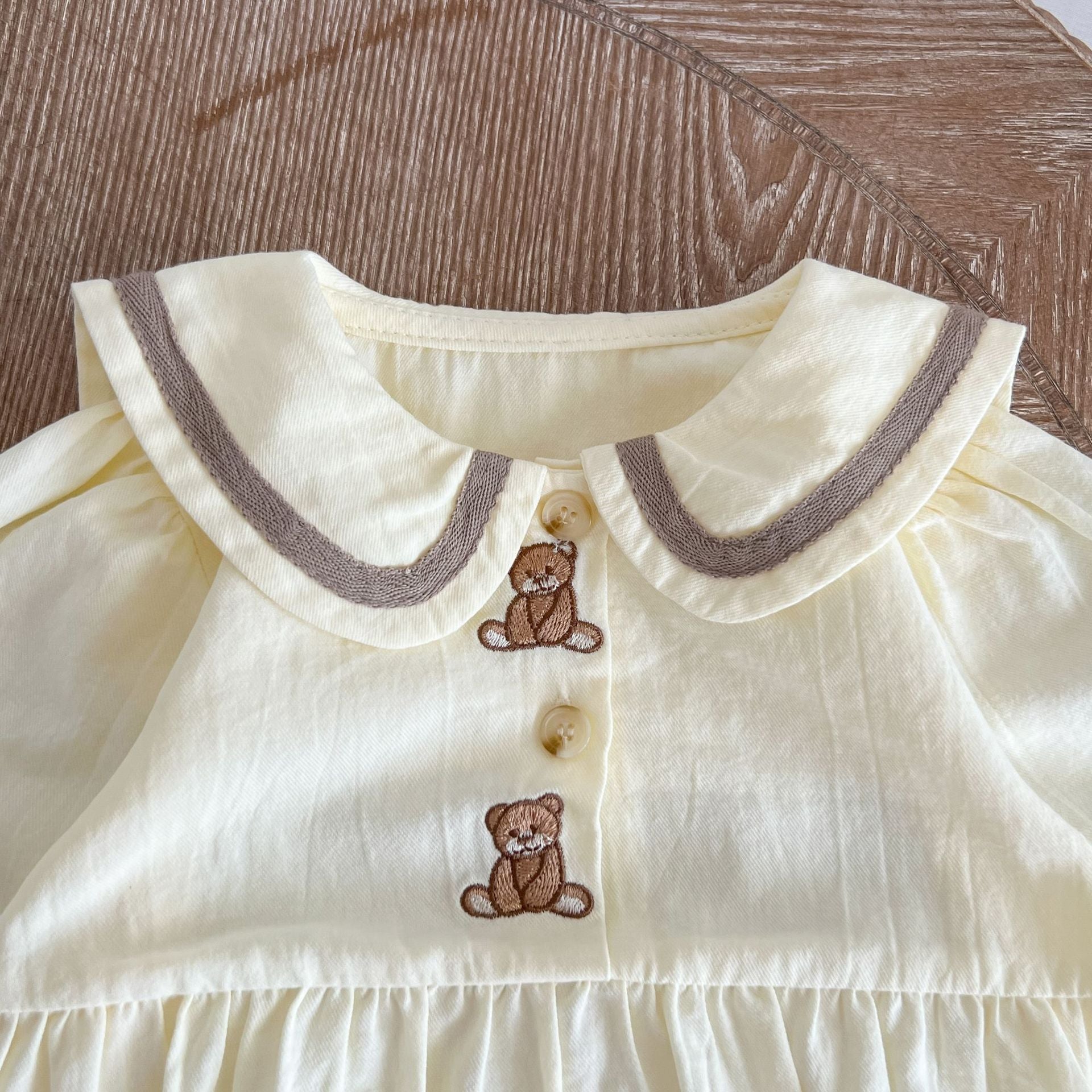 Baby Bear Embroidered Pattern Sailor Collar Long Onesie in apricot color, featuring a cute bear design and stylish collar.