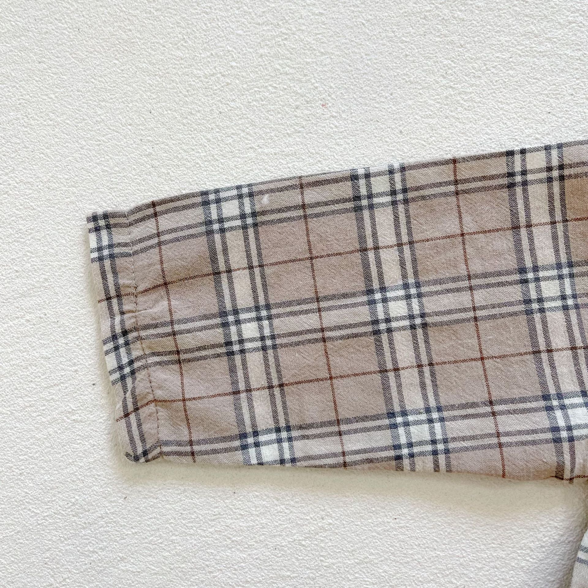 Baby boy and girl plaid pattern long-sleeved top combo with denim straps, showcasing a stylish and comfortable outfit for infants.