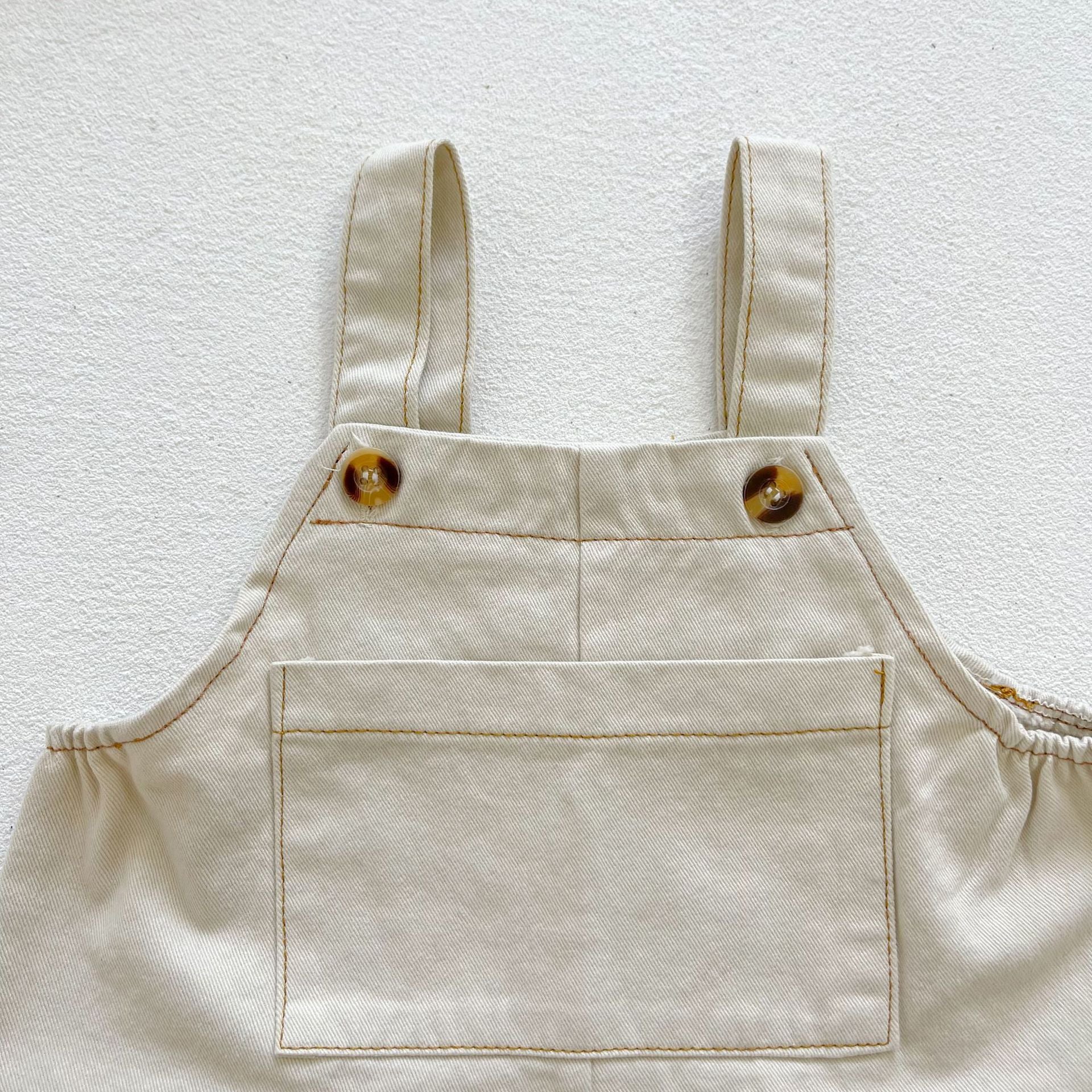 Baby boy and girl plaid pattern long-sleeved top combo with denim straps, showcasing a stylish and comfortable outfit for infants.