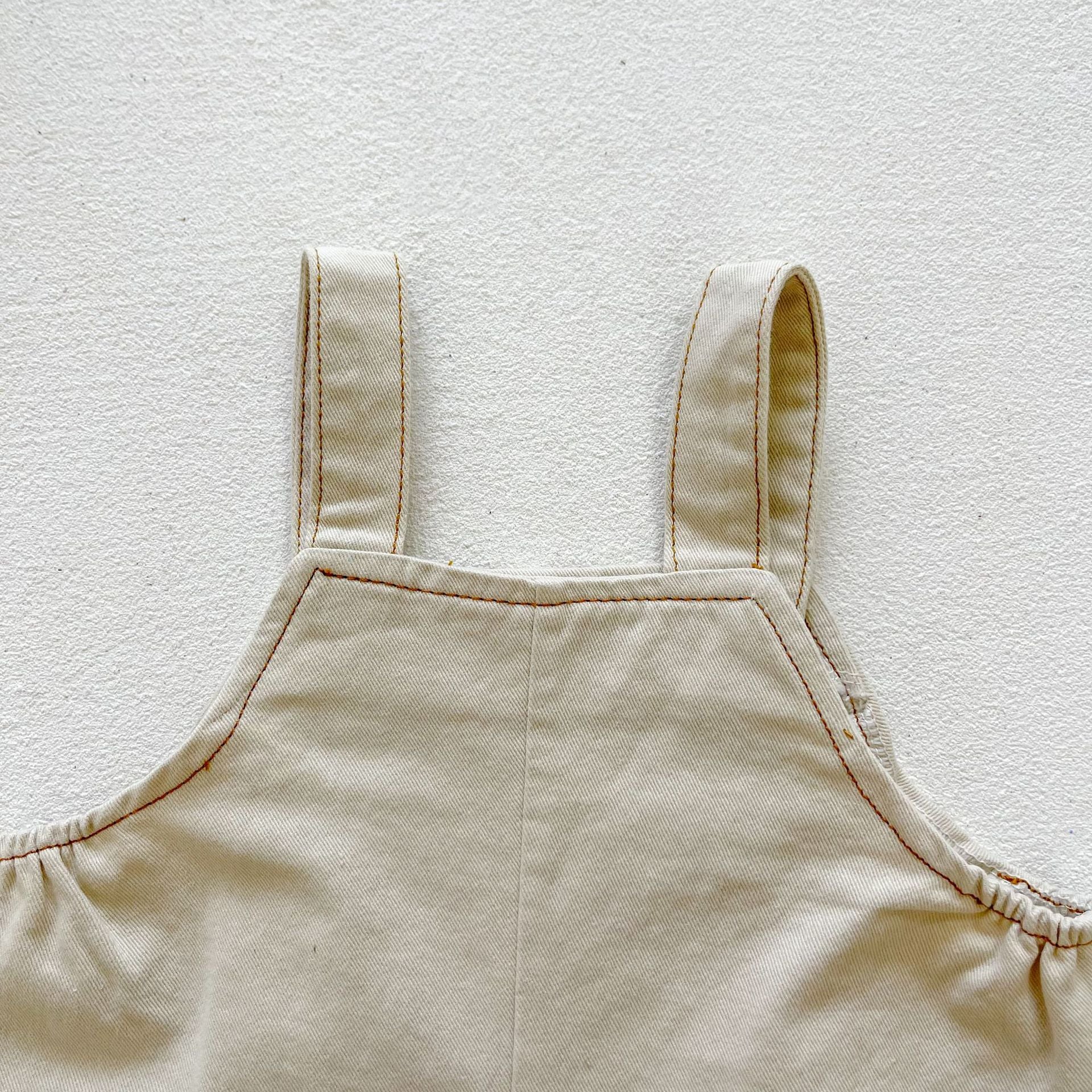 Baby boy and girl plaid pattern long-sleeved top combo with denim straps, showcasing a stylish and comfortable outfit for infants.