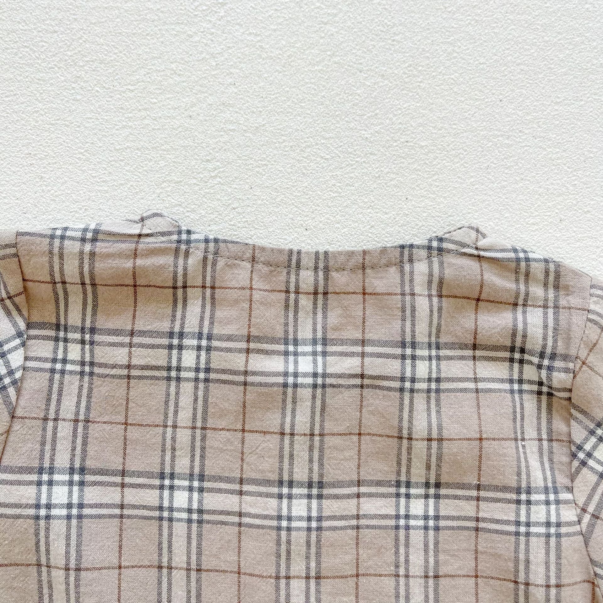 Baby boy and girl plaid pattern long-sleeved top combo with denim straps, showcasing a stylish and comfortable outfit for infants.