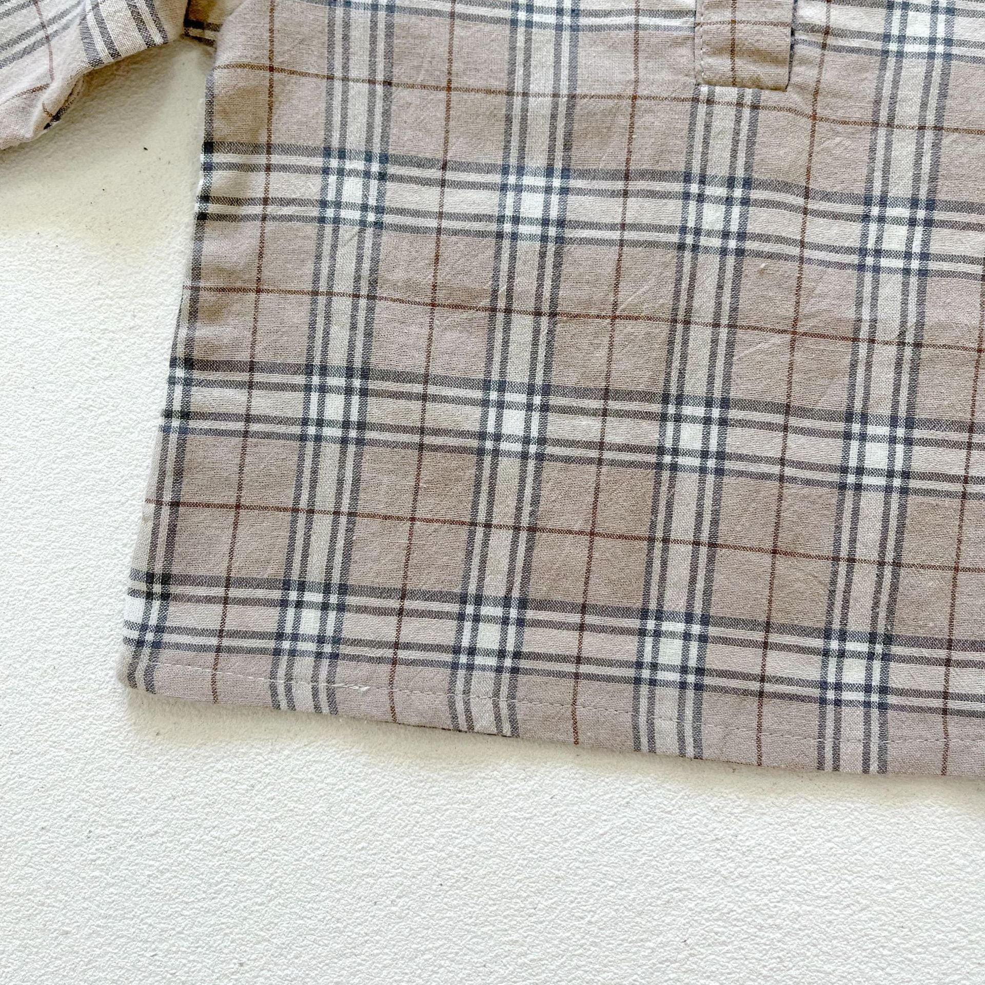Baby boy and girl plaid pattern long-sleeved top combo with denim straps, showcasing a stylish and comfortable outfit for infants.