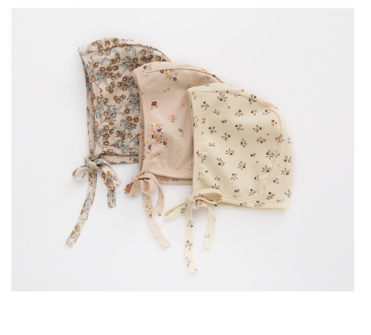 A cozy Baby Boy And Girl Print Pattern Belt Design Cotton Tire Cap Warm Hat in various colors with an adorable animal print, perfect for toddlers.