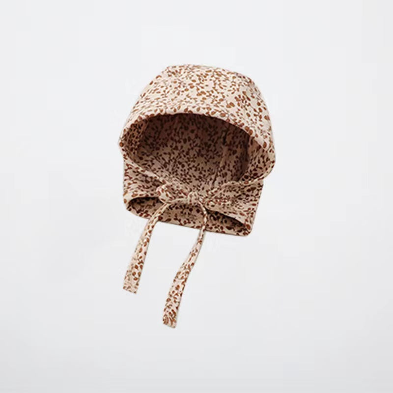 A cozy Baby Boy And Girl Print Pattern Belt Design Cotton Tire Cap Warm Hat in various colors with an adorable animal print, perfect for toddlers.