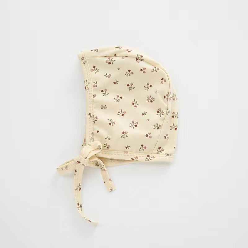 A cozy Baby Boy And Girl Print Pattern Belt Design Cotton Tire Cap Warm Hat in various colors with an adorable animal print, perfect for toddlers.