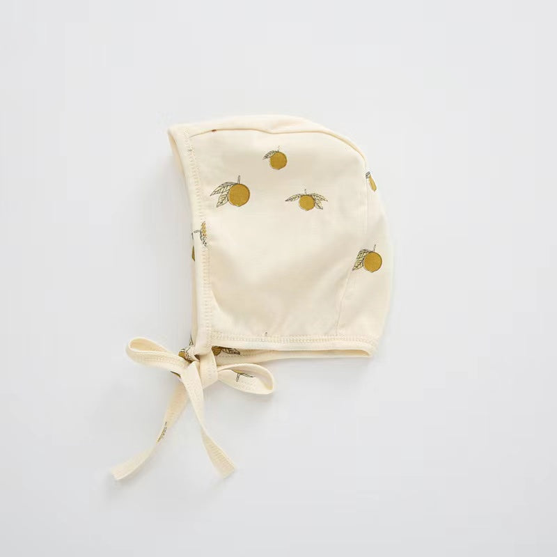 A cozy Baby Boy And Girl Print Pattern Belt Design Cotton Tire Cap Warm Hat in various colors with an adorable animal print, perfect for toddlers.