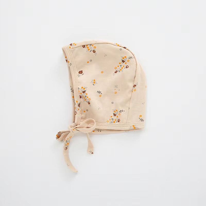 A cozy Baby Boy And Girl Print Pattern Belt Design Cotton Tire Cap Warm Hat in various colors with an adorable animal print, perfect for toddlers.