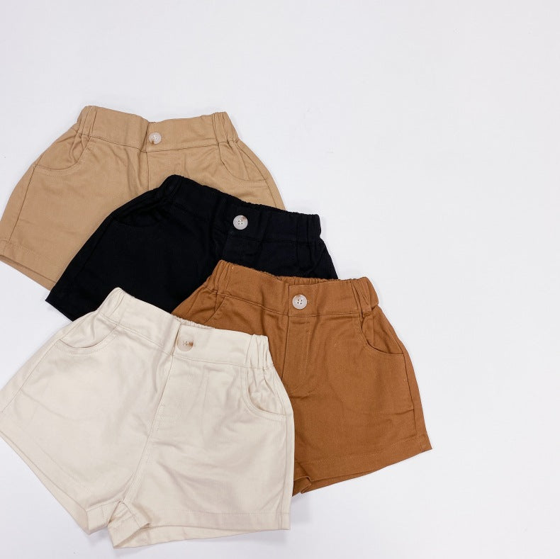 Baby boy and girl solid color denim shorts with pockets, available in white, black, khaki, and brown, perfect for summer wear.