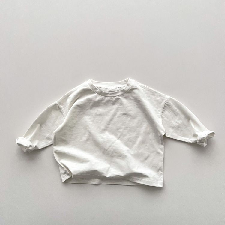 Baby boy and girl solid color pullover tops in white, black, and coffee, showcasing long sleeves and soft cotton fabric.