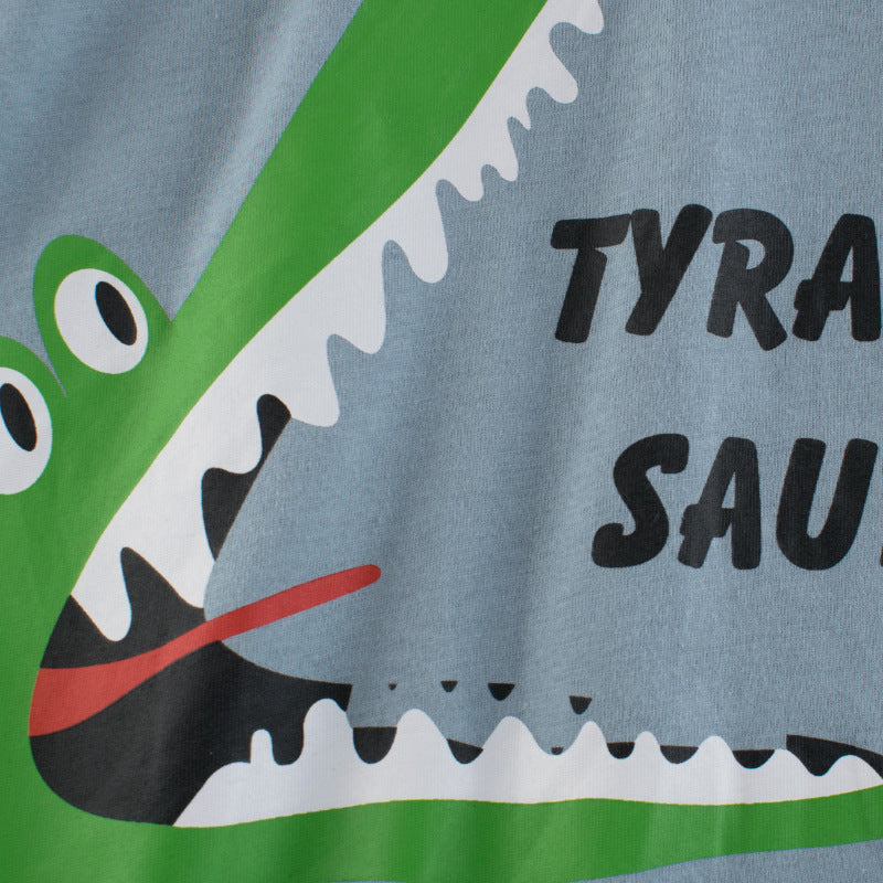 Baby boy wearing a blue short-sleeved T-shirt with vibrant animal print design, perfect for summer outings.