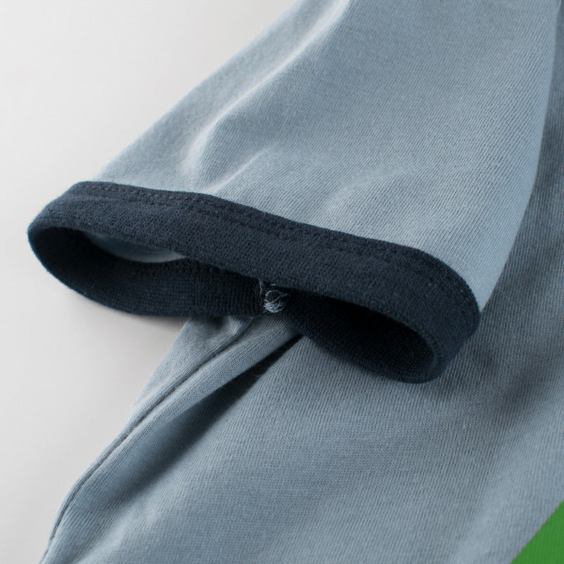 Baby boy wearing a blue short-sleeved T-shirt with vibrant animal print design, perfect for summer outings.