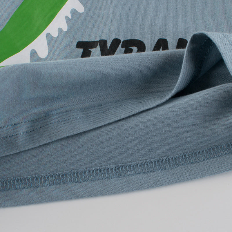 Baby boy wearing a blue short-sleeved T-shirt with vibrant animal print design, perfect for summer outings.