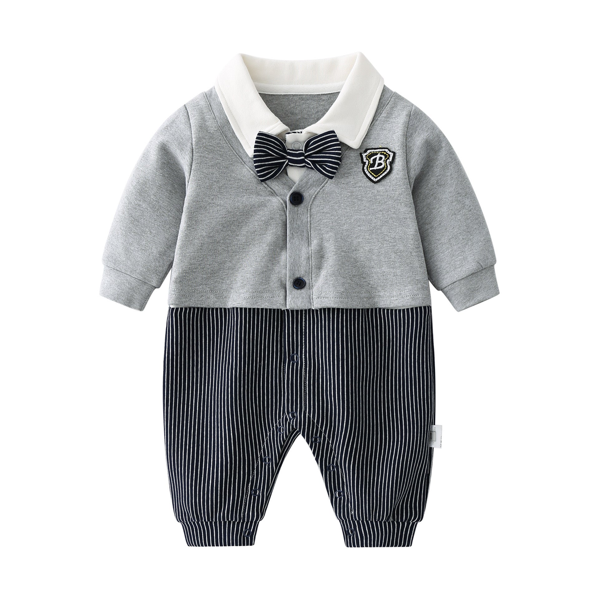 Baby boy wearing a stylish grey striped romper with badge patch and bow tie, showcasing a snap button front design.