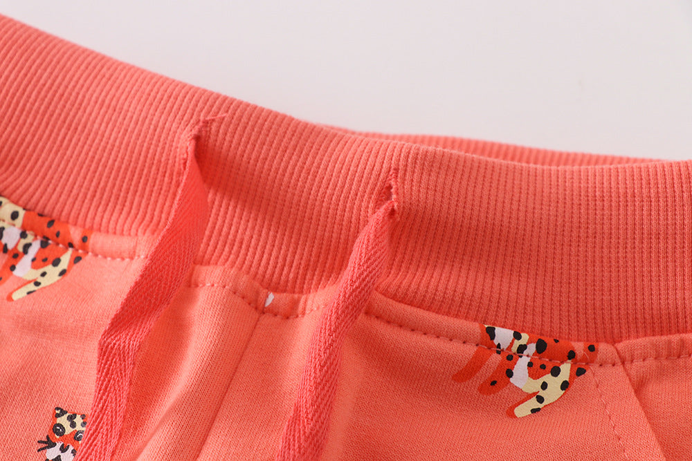 Baby boy soft cotton trousers featuring a cartoon animal pattern in vibrant orange color, perfect for playful days.