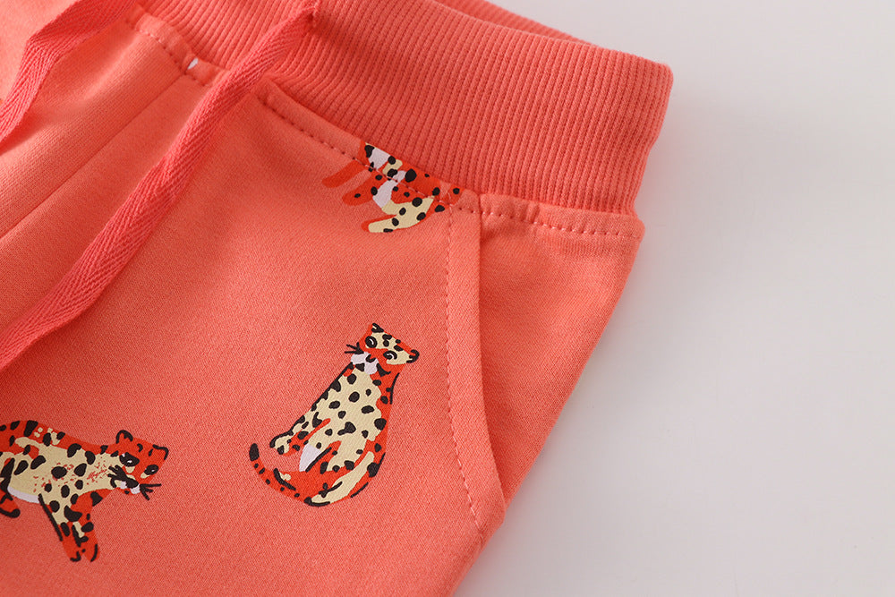 Baby boy soft cotton trousers featuring a cartoon animal pattern in vibrant orange color, perfect for playful days.