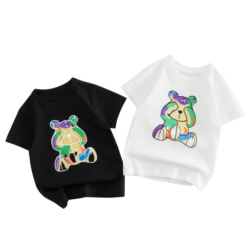 Baby boy wearing a soft cotton tee with a cartoon bear graphic, available in white and black colors.