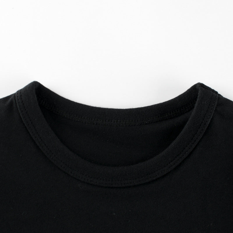 Baby boy wearing a soft cotton tee with a cartoon bear graphic, available in white and black colors.