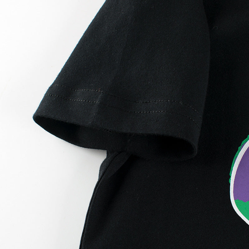 Baby boy wearing a soft cotton tee with a cartoon bear graphic, available in white and black colors.