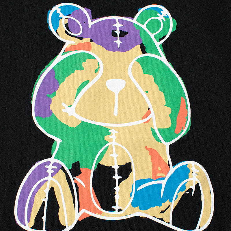 Baby boy wearing a soft cotton tee with a cartoon bear graphic, available in white and black colors.