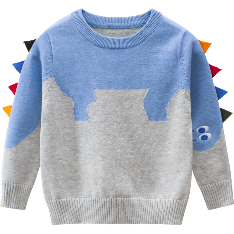 Baby boy wearing a cartoon dinosaur embroidered knitted sweater in blue, showcasing a playful design and cozy fit.
