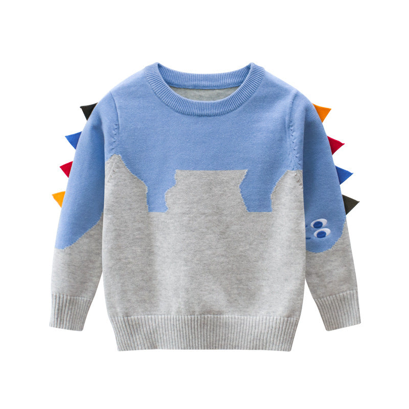 Baby boy wearing a cartoon dinosaur embroidered knitted sweater in blue, showcasing a playful design and cozy fit.
