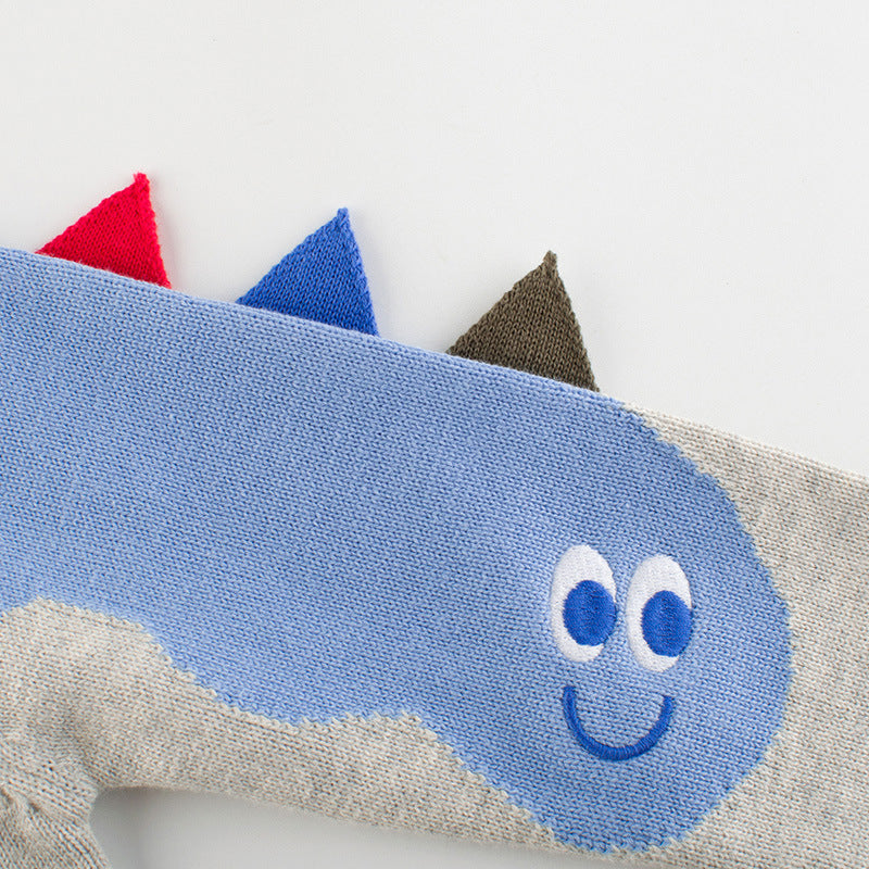 Baby boy wearing a cartoon dinosaur embroidered knitted sweater in blue, showcasing a playful design and cozy fit.