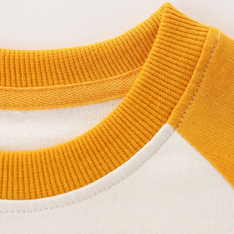 Baby boy wearing a colorful cotton hoodie with a cartoon dinosaur pattern, perfect for playful adventures.