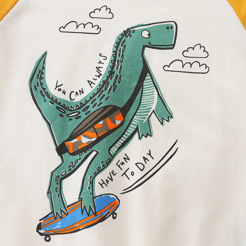 Baby boy wearing a colorful cotton hoodie with a cartoon dinosaur pattern, perfect for playful adventures.