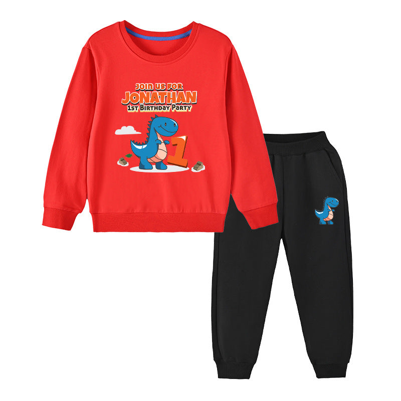 Baby boy wearing a cute cartoon dinosaur print hoodie and trousers set, showcasing vibrant colors and playful design.