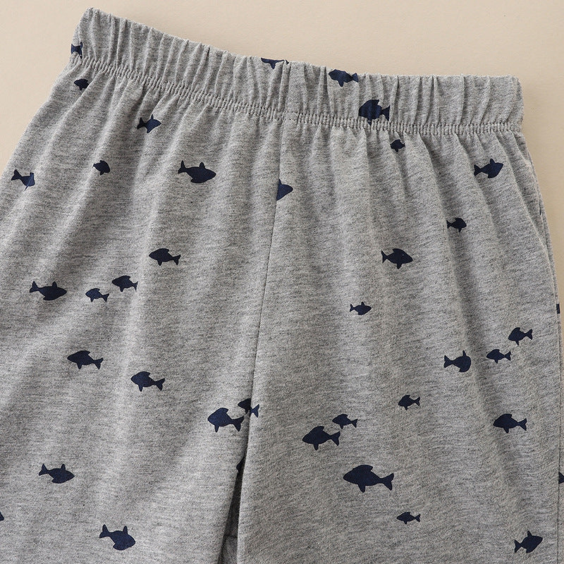 Baby boy wearing a sleeveless summer set featuring a cartoon dog graphic, made of soft cotton, perfect for warm weather.