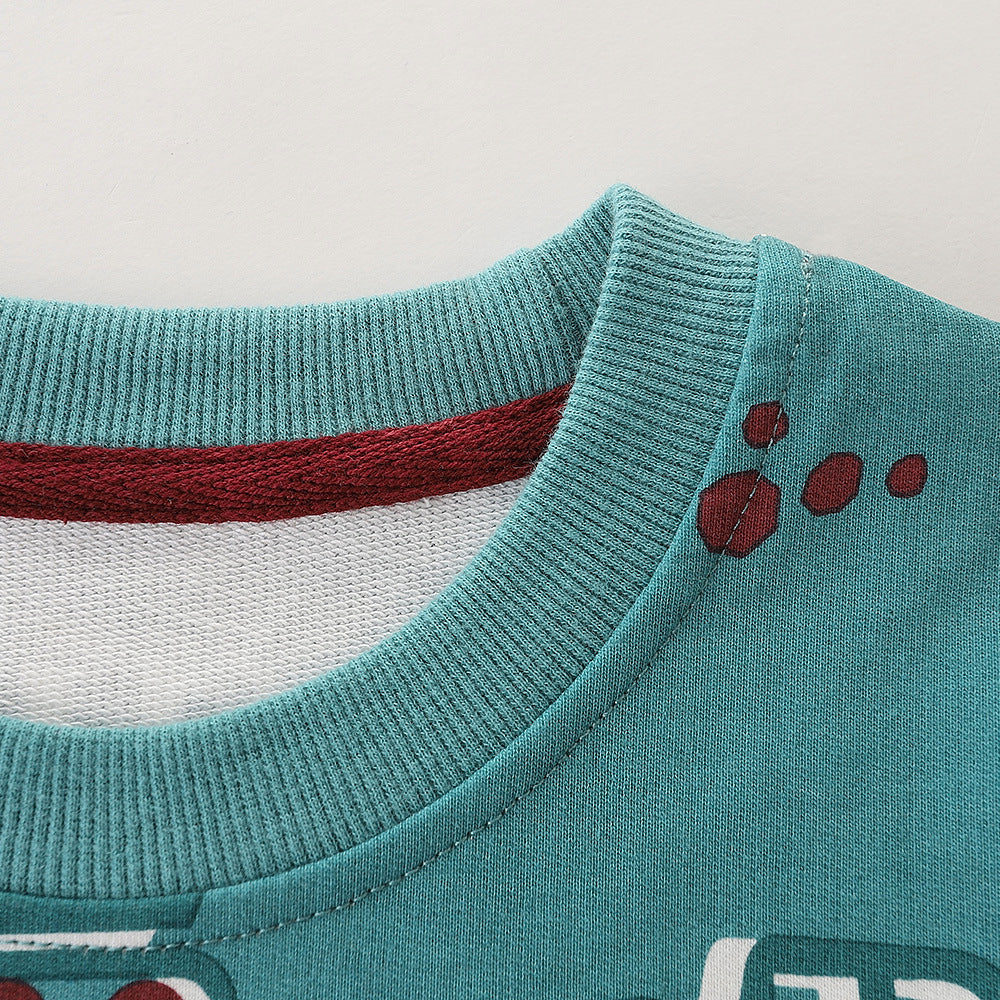 Baby boy wearing a green pullover hoodie with a cartoon truck graphic, perfect for spring and autumn adventures.