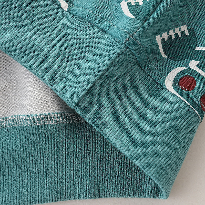 Baby boy wearing a green pullover hoodie with a cartoon truck graphic, perfect for spring and autumn adventures.