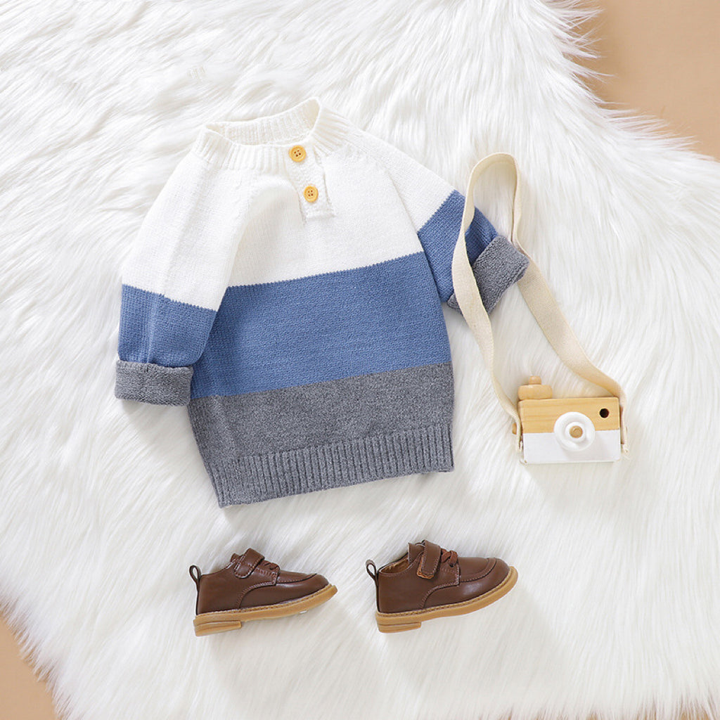 Baby boy wearing a stylish color block pullover with quarter-button design in blue and green, perfect for spring and autumn.