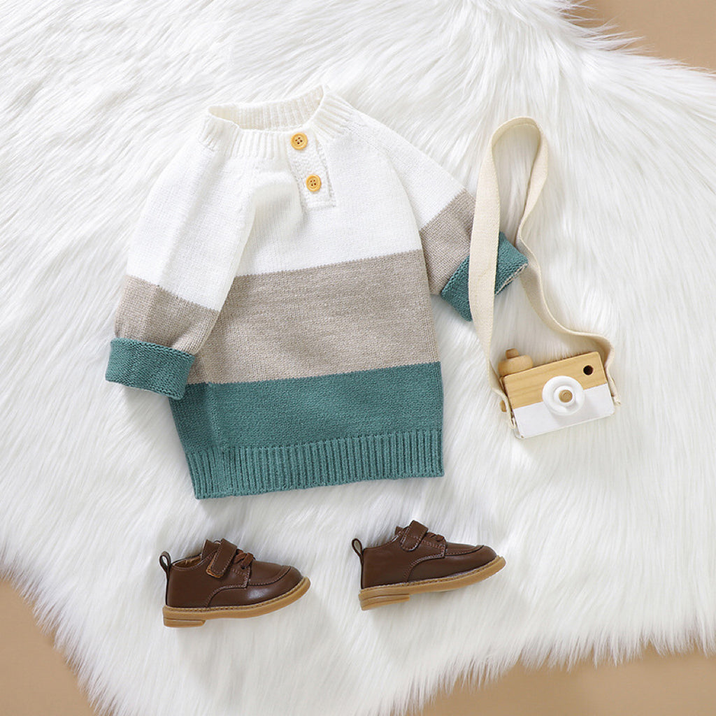 Baby boy wearing a stylish color block pullover with quarter-button design in blue and green, perfect for spring and autumn.