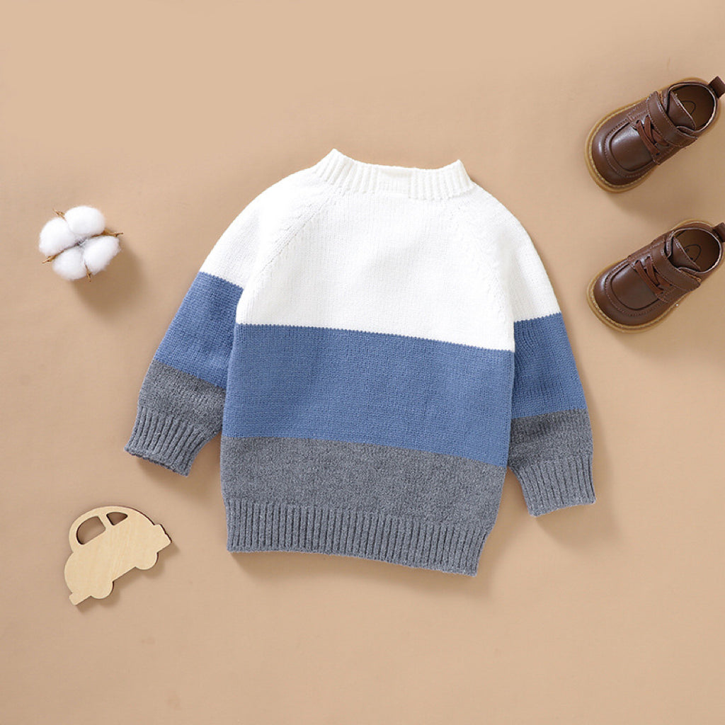 Baby boy wearing a stylish color block pullover with quarter-button design in blue and green, perfect for spring and autumn.