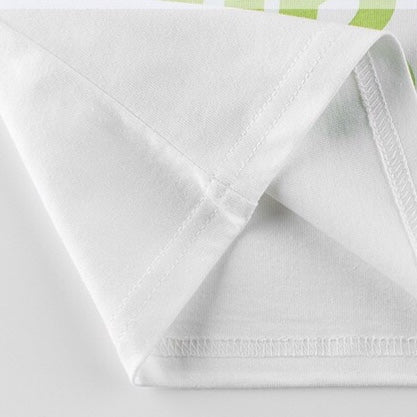 A colorful long-sleeved shirt for baby boys featuring a vibrant blue and orange design with slogan prints and patchwork details.