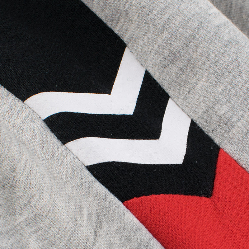 Baby boy wearing a stylish contrast design hoodie with side print trousers, showcasing vibrant colors and a playful striped pattern.