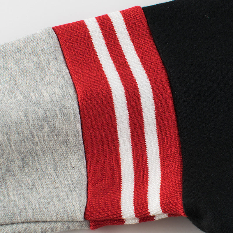 Baby boy wearing a stylish contrast design hoodie with side print trousers, showcasing vibrant colors and a playful striped pattern.