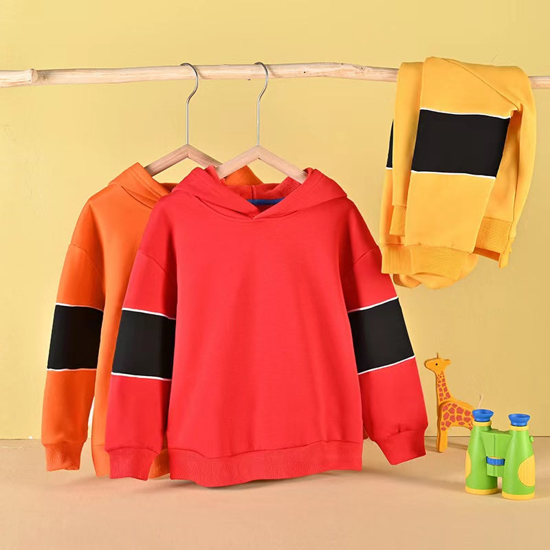 A cozy baby boy wearing a thickened fleece hoodie with contrast tape design in vibrant colors, perfect for spring and autumn.