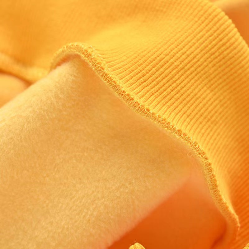 A cozy baby boy wearing a thickened fleece hoodie with contrast tape design in vibrant colors, perfect for spring and autumn.