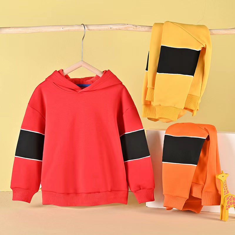 A cozy baby boy wearing a thickened fleece hoodie with contrast tape design in vibrant colors, perfect for spring and autumn.