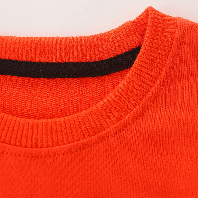 Baby boy wearing a cozy orange dinosaur embroidered pullover hoodie, showcasing a playful design perfect for toddlers.